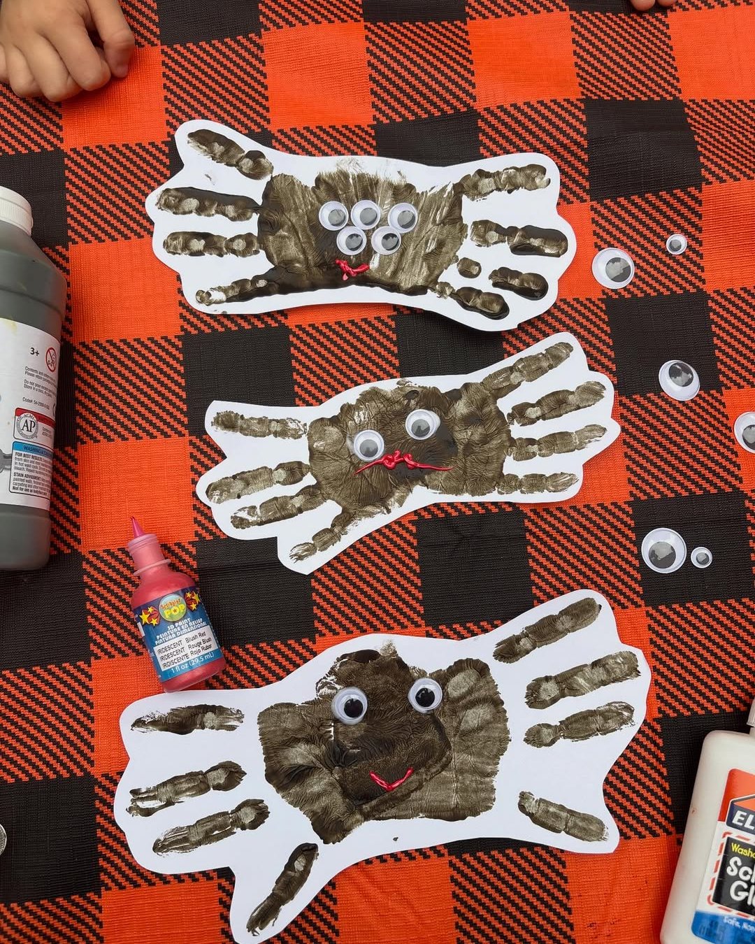 Halloween Crafts for Kids featuring painted handprint spiders with googly eyes