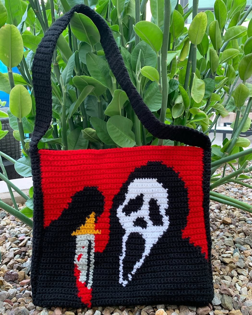 Halloween Crochet Ideas featuring a black, red, and white crochet tote with a ghost and candle design