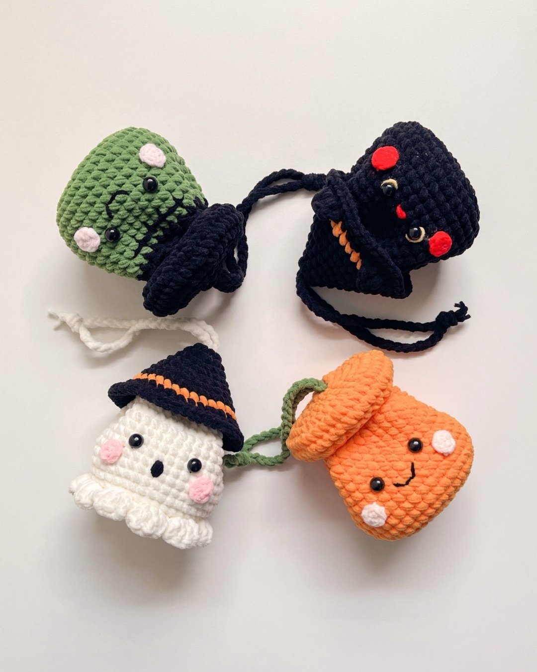 Crocheted Halloween garland with a green monster, black cat, ghost, and pumpkin