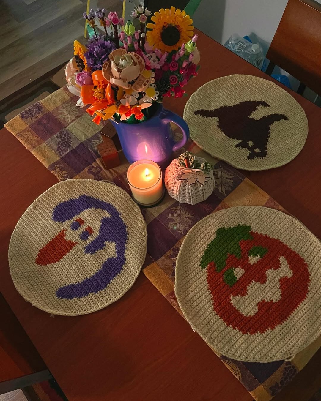 Halloween Crochet Ideas featuring ghost, witch, and pumpkin character placemats on a festive table