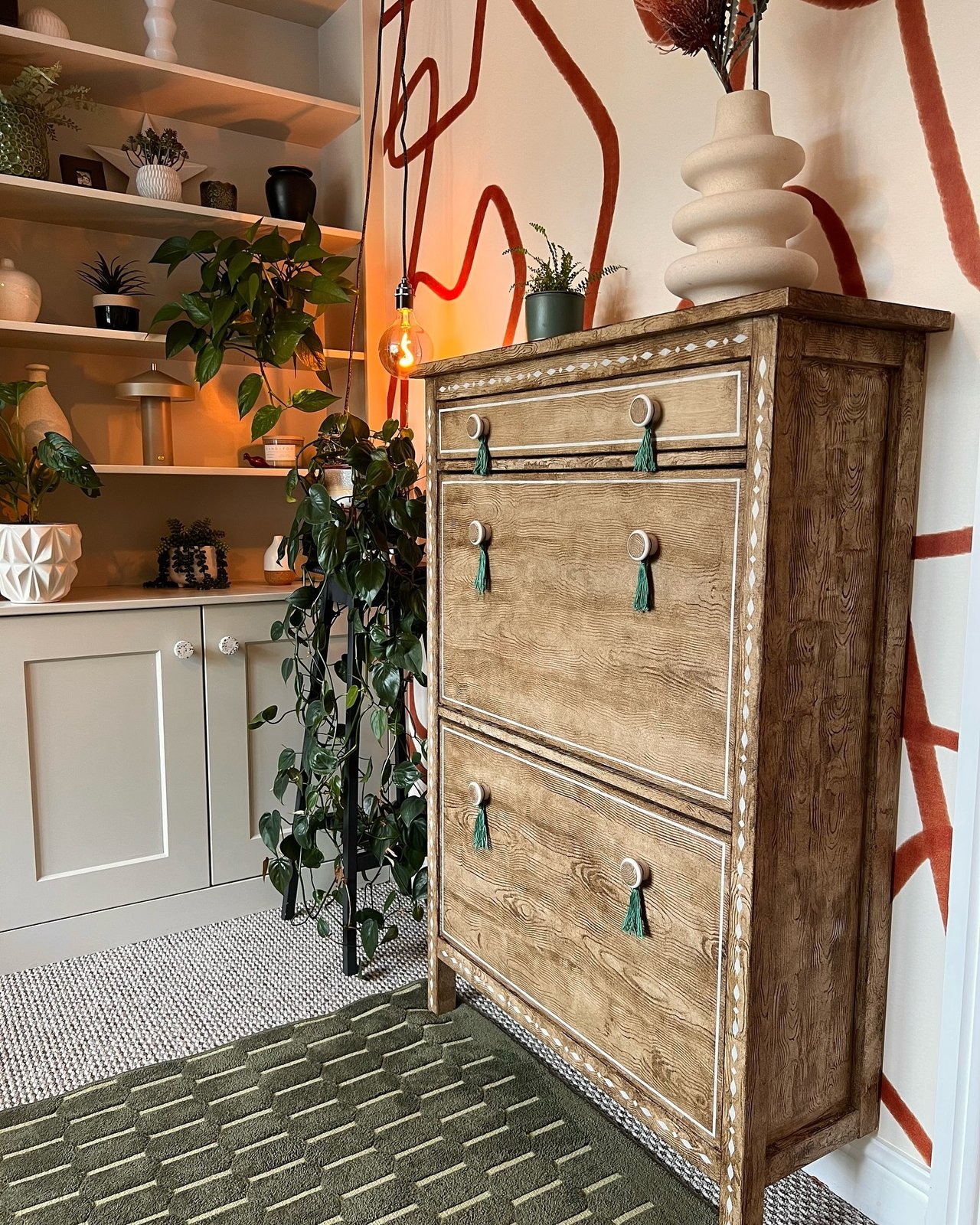 Faux wood grain HEMNES shoe cabinet with tassel handles and decorative painted trim
