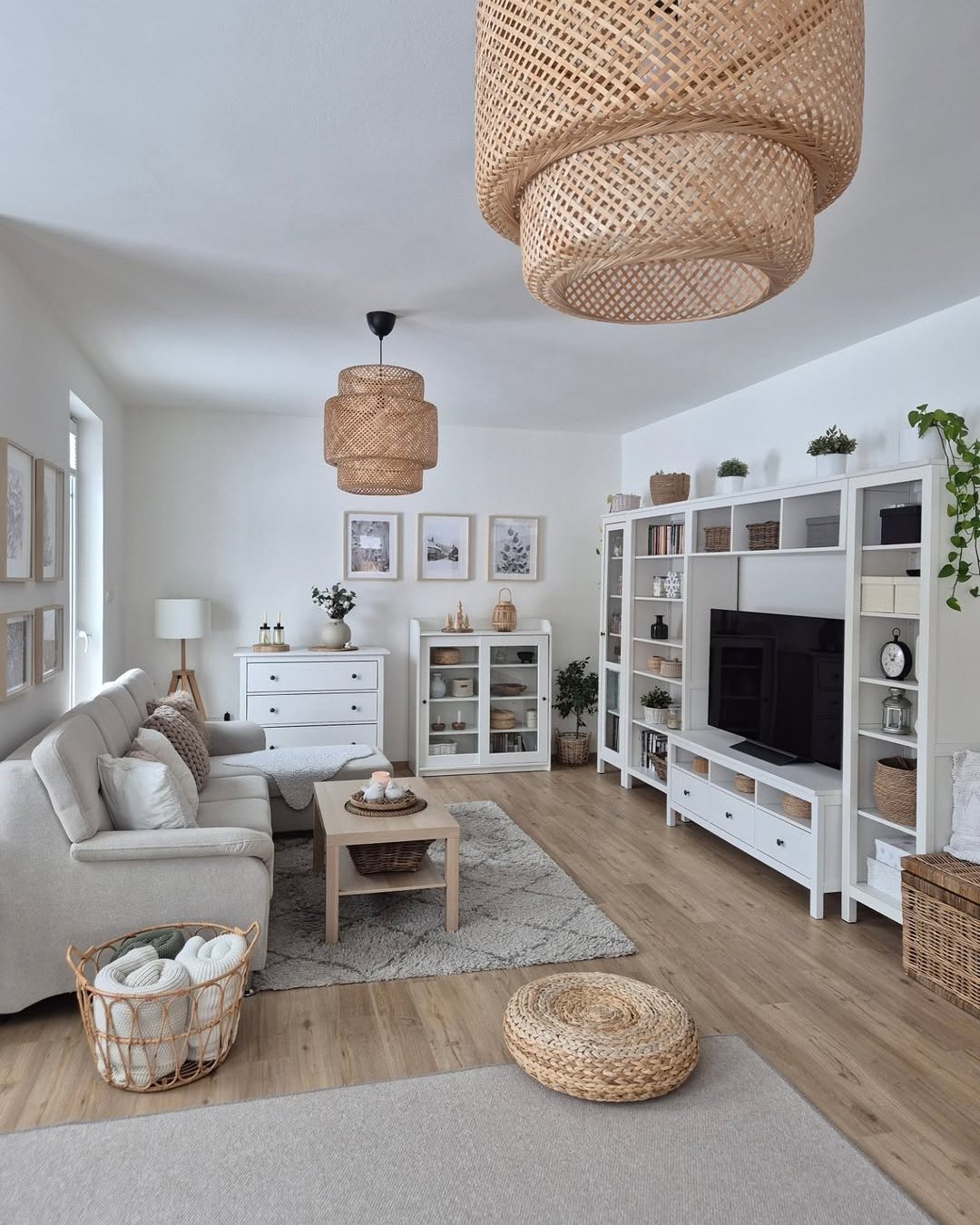 Soft neutral living room with layered rattan lights, woven baskets, plush textiles, and cozy winter styling